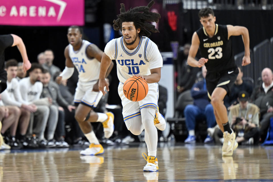 UCLA guard Tyger Campbell (10) brings the ball up court against Colorado during the second half of an NCAA college basketball game in the quarterfinals of the Pac-12 Tournament, Thursday, March 9, 2023, in Las Vegas. (AP Photo/David Becker)