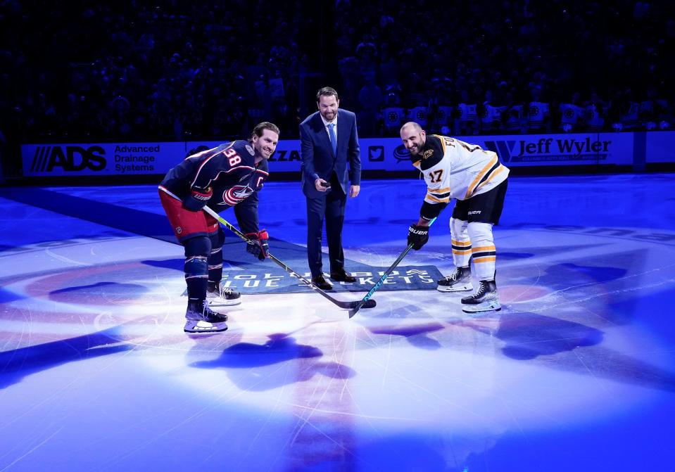 Former Columbus Blue Jackets player Rick Nash takes ceremonial puck drop with captains Boone Jenner and Boston Bruins Nick Foligno prior to the NHL hockey game against the Boston Bruins at Nationwide Arena in Columbus on March 5, 2022. 