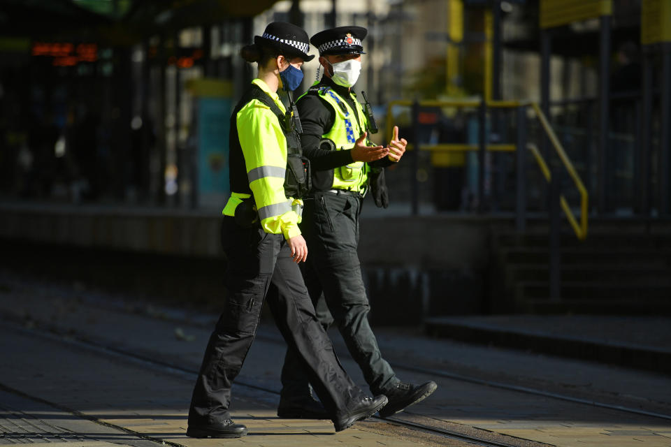 Police officers wearing face masks in St Peter's Square, Manchester, as the Government is preparing to impose stringent new coronavirus controls on 2.8 million people after talks with the local leaders for Greater Manchester failed to reach agreement. Leaders have been given until midday on Tuesday to reach a deal, or face unilateral Government action, after 10 days of negotiations failed to reach an agreement. (Photo by Jacob King/PA Images via Getty Images)