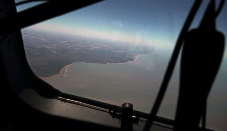 The coast of Argentina is seen from the Boeing P-8A Poseidon aircraft during the search for the ARA San Juan submarine missing at sea, Argentina November 22, 2017. Picture taken November 22, 2017. REUTERS/Magali Cervantes