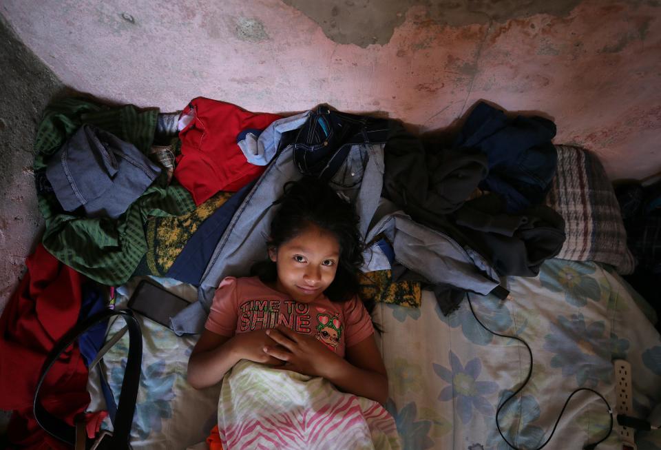Ten-year-old Guatemalan asylum seeker Monica Sical Ramos lays on a beat up mattress on the floor of a house in south-center Juarez in June 2019. She and her father Jose Francisco Sical were subjected to President Trump's "Remain in Mexico" policy, also known as MPP, as they attempt to seek asylum in the United States.