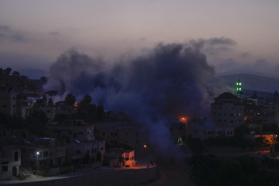 Smoke rises as Israeli troops blow up the house of Palestinian militant Diaa Hamarsheh in the West Bank village of Yabed, Thursday, June 2, 2022. Hamarsheh was shot and killed by Israeli police after he killed three Israelis and two Ukrainian citizens in a deadly shooting attack in Bnei Brak on March 29, 2021. Israeli officials say the demolitions deter future attacks, while rights groups view it as a form of collective punishment. (AP Photo/Majdi Mohammed)