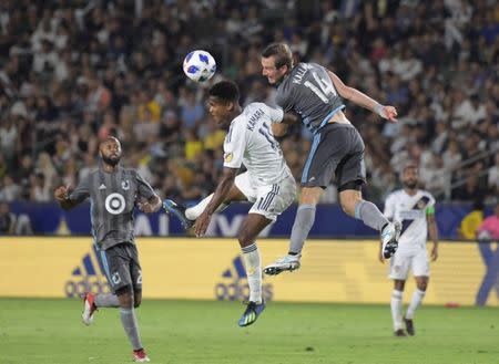 Aug 11, 2018; Carson, CA, USA; LA Galaxy forward Ola Kamara (11) and Minnesota United FC goalkeeper Alex Kapp (24) battle for the ball in the second half at StubHub Center. The teams played to a 2-2 tie. Mandatory Credit: Kirby Lee-USA TODAY Sports