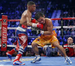 Yuriorkis Gamboa, from Miami, Fla., left, connects against Michael Farenas, from the Philippines, during their WBA interim super featherweight title fight Saturday, Dec. 8, 2012, in Las Vegas. Gamboa went on to win the bout by unanimous decision. (AP Photo/Eric Jamison)