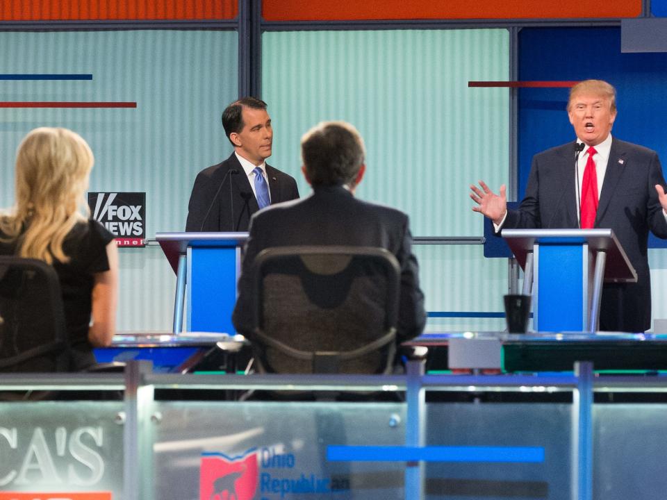 Republican presidential candidate Donald Trump, right, speaks to moderators from left foreground, Megyn Kelly and Chris Wallace during the first Republican presidential debate in 2015, in Cleveland.