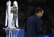 <p>Juventus coach Massimiliano Allegri walks past the UEFA Champions League trophy after the match </p>