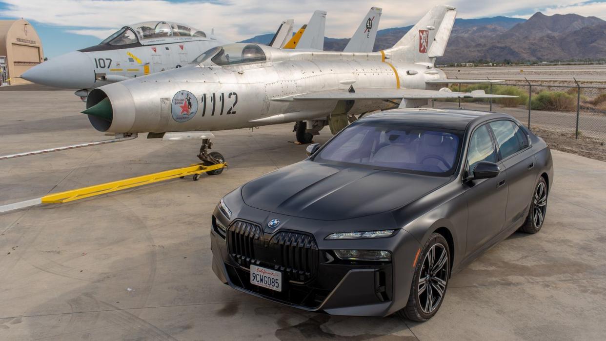 a car parked in front of a group of jets