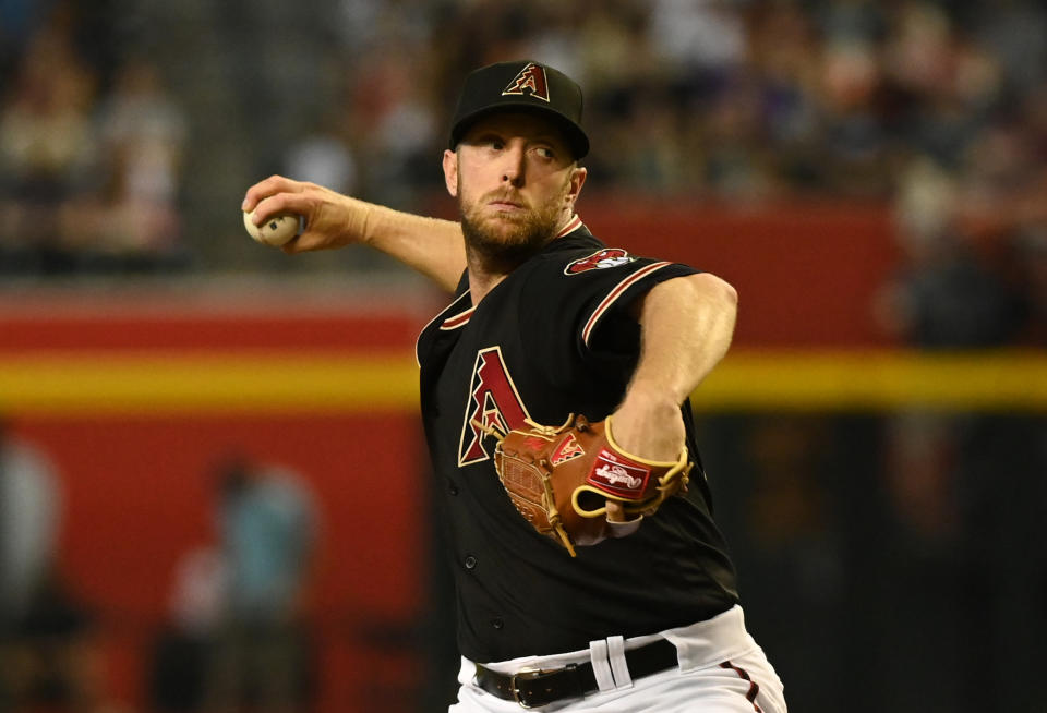 Merrill Kelly #29 of the Arizona Diamondbacks delivers a pitch against the Colorado Rockies at Chase Field during an MLB game