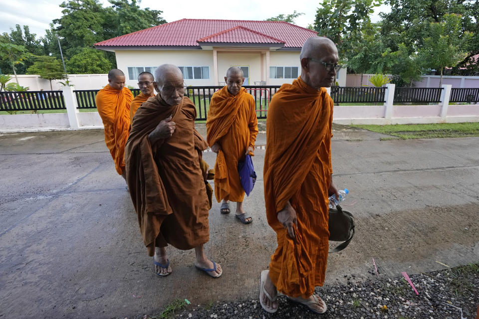 Buddhist monks walk in front of former childcare center before the Buddhist ceremony in the rural town of Uthai Sawan, in Nong Bua Lamphu province, northeastern Thailand, Friday, Oct. 6, 2023. A memorial service takes place to remember those who were killed in a grisly gun and knife attack at a childcare center. A former police officer killed 36 children and teachers in the deadliest rampage in Thailand's history one year ago. (AP Photo/Sakchai Lalit)