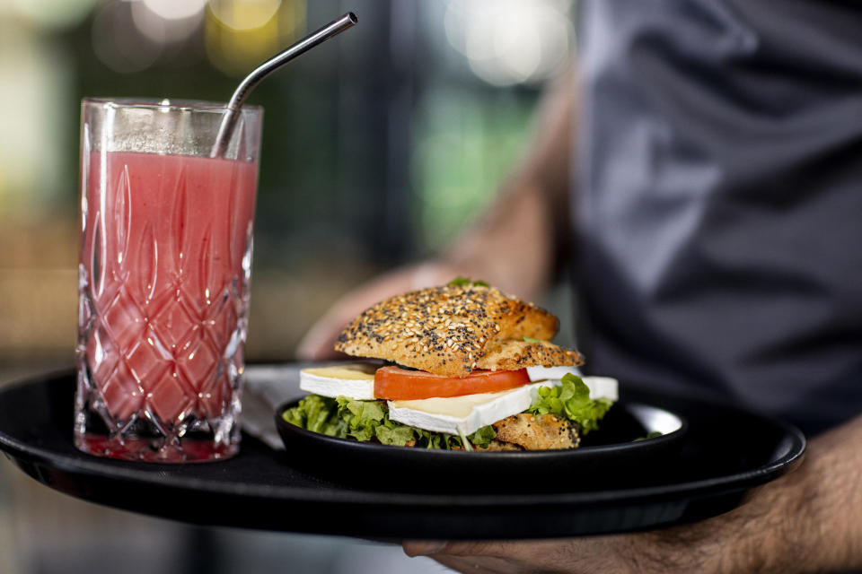 close up of someone holding a tray of food and a drink