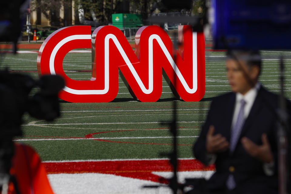 FILE - A journalist records video near a CNN sign on an athletic field outside the Clements Recreation Center where the CNN/New York Times will host the Democratic presidential primary debate at Otterbein University, Monday, Oct. 14, 2019, in Westerville, Ohio. Mark Thompson was appointed as chair and CEO of CNN by David Zaslav, head of the network's parent company, Warner Bros. Discovery, which made the announcement Wednesday, Aug. 30, 2023. Thompson replaces Chris Licht, who was fired in June, and a four-person team that had been running CNN in the interim. (AP Photo/John Minchillo, File)