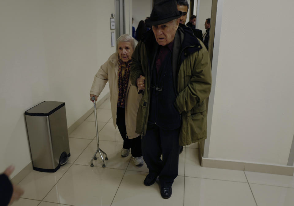 An elderly Turkish couple arrive at a polling station during the local elections in Ankara, Turkey, Sunday, March 31, 2019. Turkish citizens have begun casting votes in municipal elections for mayors, local assembly representatives and neighborhood or village administrators that are seen as a barometer of Erdogan's popularity amid a sharp economic downturn. (AP Photo/Burhan Ozbilici)