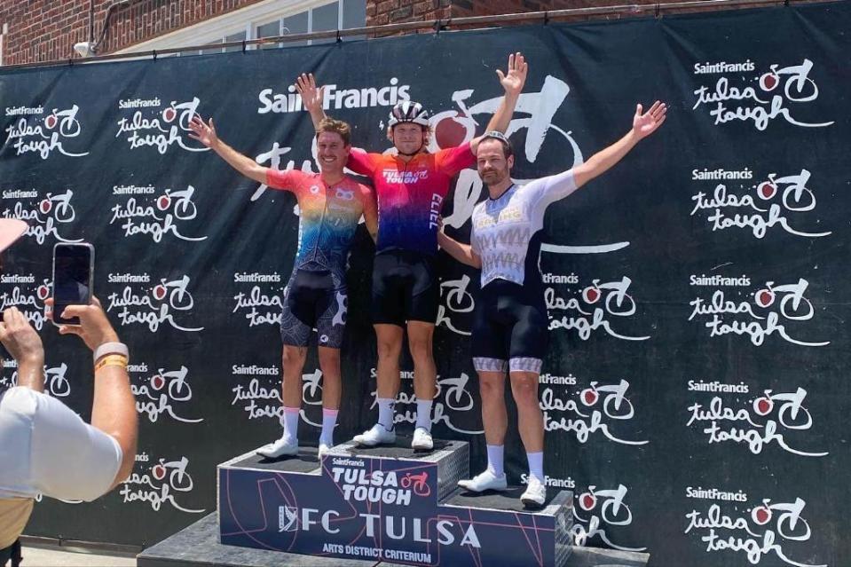 Jake Boykin, a professional cyclist and Florida State University doctoral student (middle), takes a photo with other cyclists during a racing event.
