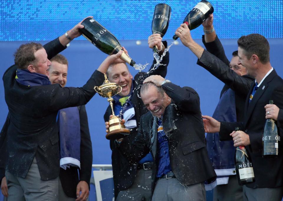 Europe players Jamie Donaldson, Henrik Stenson, Ian Poulter, Lee Westwood and Justin Rose pour champagne over captain Paul McGinley as they celebrate winning the 2014 Ryder Cup golf tournament at Gleneagles, Scotland.