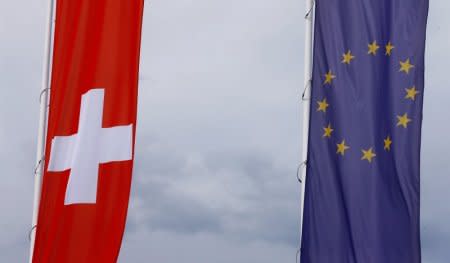 FILE PHOTO: The flags of the European Union and Switzerland flutter in the wind in Blotzheim, France June 27, 2017.     REUTERS/Arnd Wiegmann