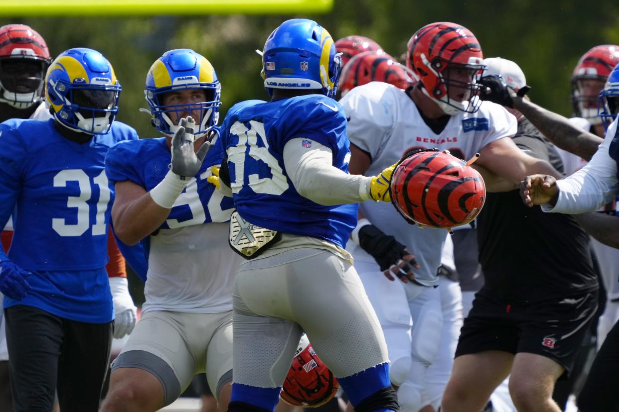 Los Angeles Rams defensive tackle Jonah Williams (92) attempts to hold back defensive tackle Aaron Donald (99) as a third scuffle escalates into a brawl during a joint preseason camp practice between the Cincinnati Bengals and the Los Angeles Rams at Paycor Stadium in Cincinnati on Thursday, Aug. 25, 2022. Practice was ended early after a third scuffle turned into a broader fight between players on both teams.