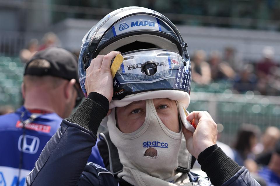 Marco Andretti puts on his helmet during qualifications for the Indianapolis 500 auto race at Indianapolis Motor Speedway, Saturday, May 18, 2024, in Indianapolis. (AP Photo/Darron Cummings)