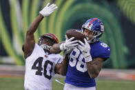 New York Giants tight end Evan Engram (88) catches a pass against Cincinnati Bengals safety Brandon Wilson (40) during the second half of NFL football game, Sunday, Nov. 29, 2020, in Cincinnati. (AP Photo/Bryan Woolston)