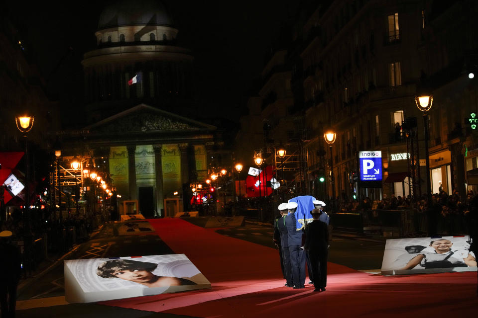 Pictures of Josephine Baker adorn the red carpet as the coffin with soils from the U.S., France and Monaco is carried towards the Pantheon monument in Paris, France, Tuesday, Nov. 30, 2021, where Baker is to symbolically be inducted, becoming the first Black woman to receive France's highest honor. Her body will stay in Monaco at the request of her family. (AP Photo/Christophe Ena)