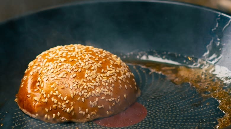 Toasting hamburger bun in pan