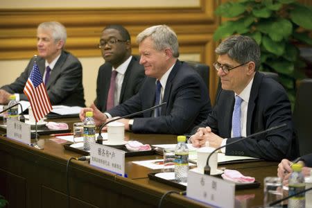 U.S. Treasury Secretary Jack Lew (R) and U.S. Ambassador to China Max Baucus, second from right, listen to a speech at the start of a meeting with Chinese Vice Premier Wang Yang at the Zhongnanhai Leadership Compound in Beijing March 30, 2015. REUTERS/Mark Schiefelbein/Pool