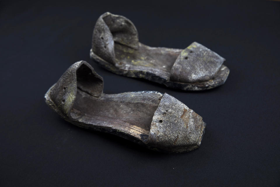 In this Thursday, March 26, 2019 photo, a pair of shoes are seen photographed after being exhumed from the scene of a mass grave at the cemetery of Paterna, near Valencia, Spain, as archaeologists conduct forensic analysis of the remains. DNA tests will be conducted in the hope of confirming the identities of those who disappeared eight decades ago, believed to have been executed by the forces of Gen. Francisco Franco during and after the 1936-39 Spanish Civil War. (AP Photo/Emilio Morenatti)