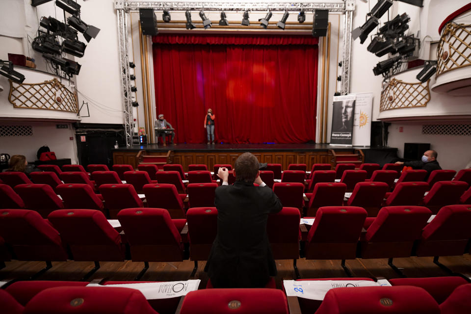 Director Visinel Balan guides inmates on stage during the final rehearsal of the play Anyone Can Make Mistakes by Romanian author Mircea Rotaru at the Nottara Theatre in Bucharest, Romania, Wednesday, Nov. 24, 2021. The Multiart festival was organized to combat stereotypes about people serving time in the penal system and to offer them a route to reintegration. (AP Photo/Andreea Alexandru)