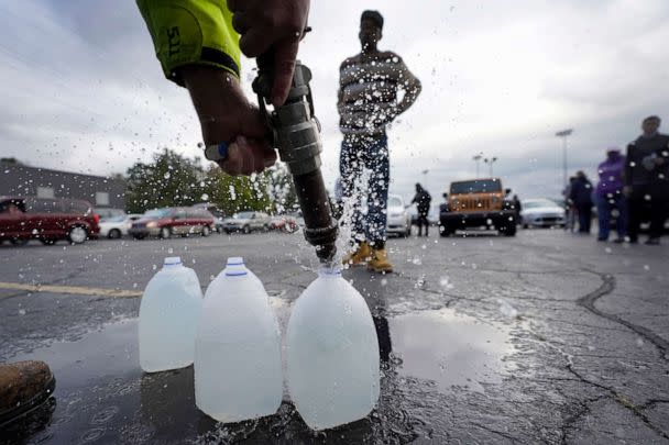 PHOTO: The Berrien County Road Department fills up jugs with non-potable water in the Benton Harbor High School parking lot, Oct. 21, 2021, in Benton Harbor, Mich. (Charles Rex Arbogast/AP, FILE)