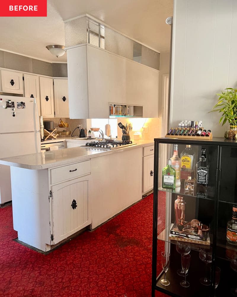 white kitchen with white cabinets and red carpeting before remodel