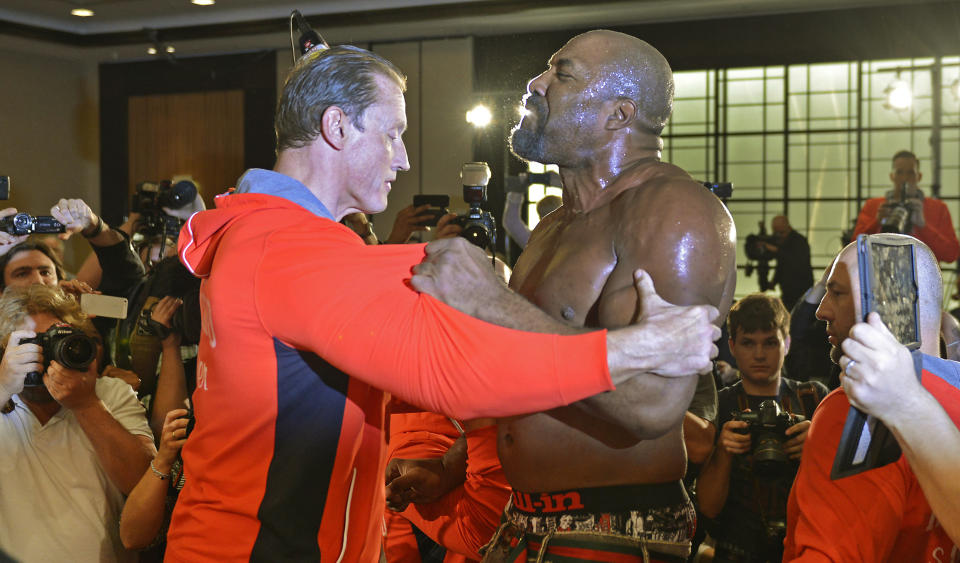 Former heavyweight world champion Shannon Briggs of the US, is pushed back by security after showing up at a press conference of boxer Wladimir Klitschko of Ukraine during a press conference ahead of Klithscko's IBF, IBO, WBO and WBA heavyweight title bout against challenger Alex Leapai from Australia-Samoa in Duesseldorf, Germany, April 22, 2014. Briggs demanded a title fight against Klitschko in the US. (AP Photo/Martin Meissner)