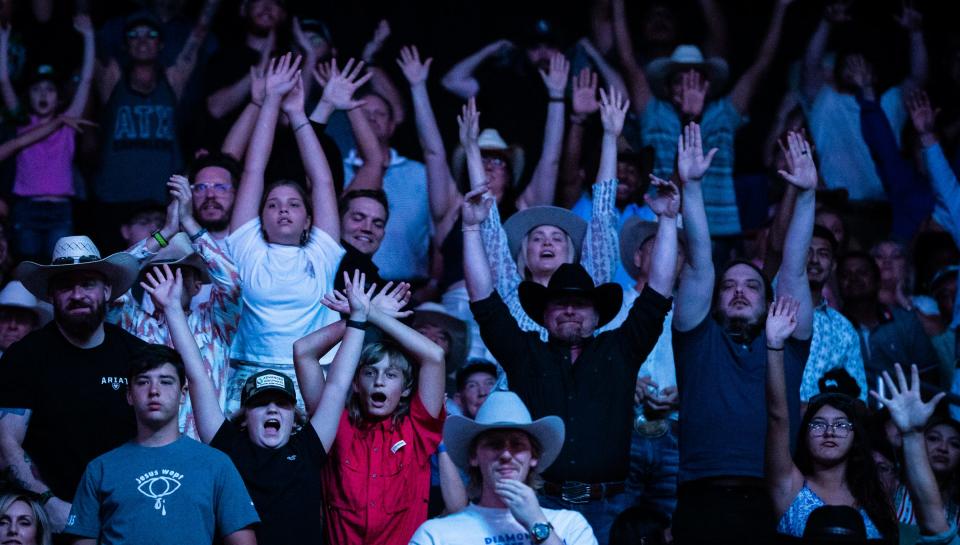 Fans at Moody Center put up their hands trying to win a T-shirt during Saturday's second day of Gambler Days.