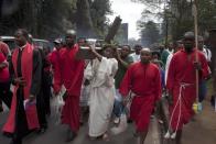 Christians of the Catholic Church in Kenya carry the cross through the streets of Nairobi, Kenya, Friday, April 18, 2014, during the Holy Week. Easter marks the end of Lent, a forty-day period of fasting, prayer, and penance. The last week of the Lent is called Holy Week, and it contains Good Friday, commemorating the crucifixion and death of Jesus. (AP Photo/Sayyid Azim)