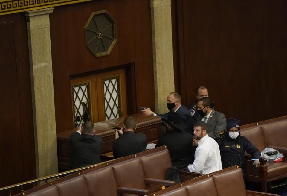 <div class="inline-image__caption"><p>U.S. Capitol police officers point their guns at a door that was vandalized in the House Chamber.</p></div> <div class="inline-image__credit">Drew Angerer/Getty</div>