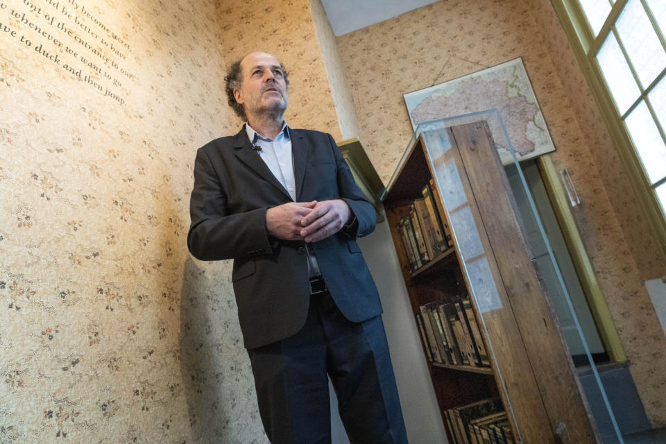 FILE - Ronald Leopold, executive director Anne Frank House, answers questions next to the passage to the secret annex during an interview in Amsterdam, Netherlands, Monday, Jan. 17, 2022. A group of Dutch historians has published an in-depth criticism of the work and conclusion of a cold case team that said it had pieced together the “most likely scenario” of who betrayed Jewish teenage diarist Anne Frank and her family. (AP Photo/Peter Dejong, File)