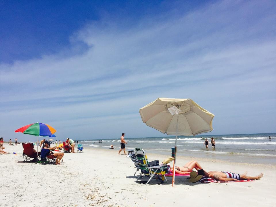 Some beachgoers take in the sun on the beaches at Anastasia State Park.