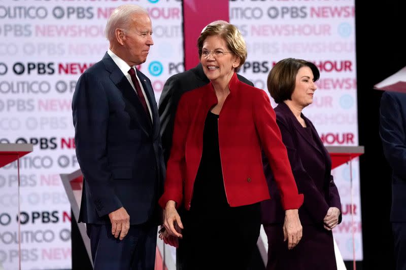 Candidates Warren, Biden and Klobuchar before the start of the sixth 2020 U.S. Democratic presidential candidates campaign debate in Los Angeles, California, U.S.