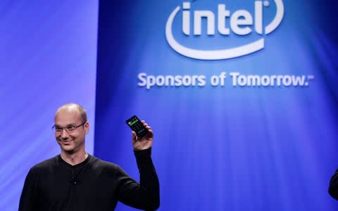 In this Tuesday, Sept. 13, 2011 file photo, Google Senior Vice President of Mobile, Andy Rubin, holds up a Google Android phone running on an Intel chip at the Intel Developer Forum in San Francisco - Credit: Paul Sakuma/AP