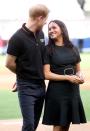 <p>Harry smiles down at Meghan as they attend the Boston Red Sox against the New York Yankees baseball game at London Stadium.</p>