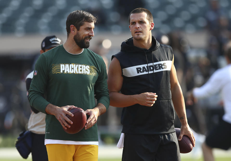 Green Bay Packers quarterback Aaron Rodgers, left, talks with Oakland Raiders quarterback Derek Carr before an NFL preseason football game between the Raiders and the Packers in Oakland, Calif., Friday, Aug. 24, 2018. (AP Photo/Ben Margot)