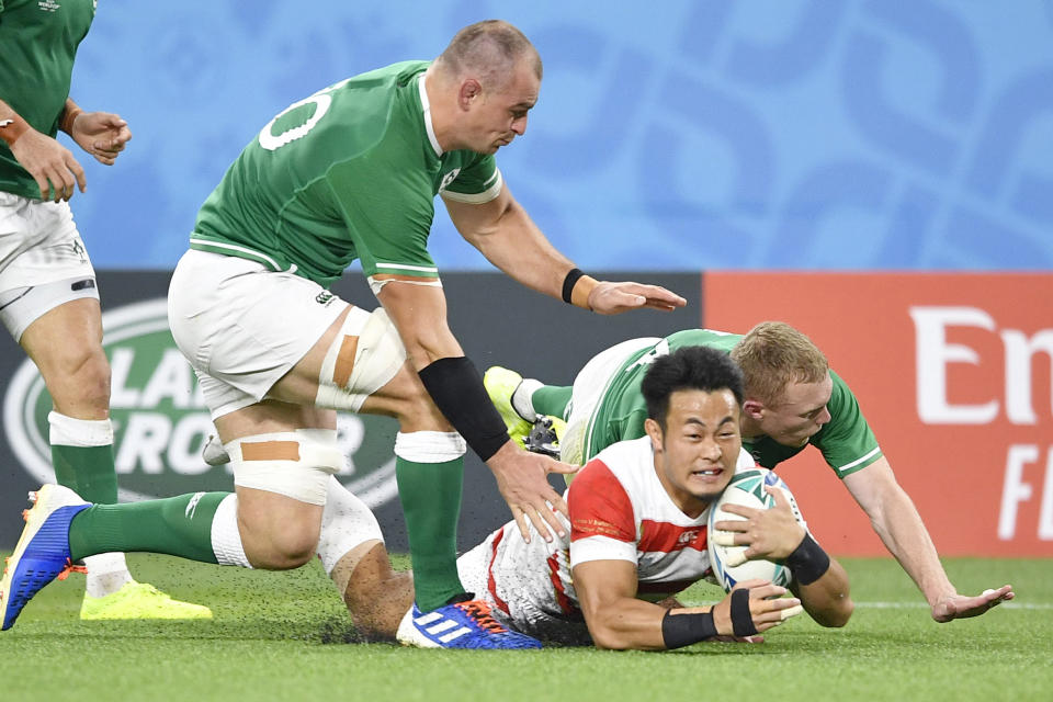 Japan's Kenki Fukuoka, bottom, scores a try against Ireland's defense during the Rugby World Cup Pool A game at Shizuoka Stadium Ecopa between Japan and Ireland in Shizuoka, Japan, Saturday, Sept. 28, 2019. (Tsuyoshi Ueda/Kyodo News via AP)