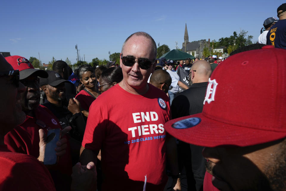 United Auto Workers President Shawn Fain talks with members at the Labor Day parade in Detroit, Monday, Sept. 4, 2023. Fain has become an outspoken and aggressive union member and leader. At the time of his March election, Fain vowed to take a more confrontational stance in negotiating with big automakers — as well as clean up the union and unite members following a wide-ranging scandal that landed two former presidents in prison. (AP Photo/Paul Sancya)