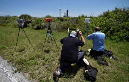 Photographers set up remote cameras for the launch of a SpaceX Falcon Heavy rocket, carrying the U.S. Air Force's Space Test Program-2 mission, at the Kennedy Space Center in Cape Canaveral