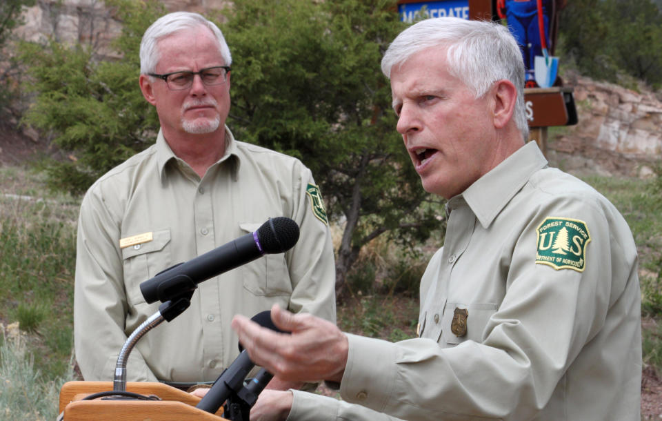 U.S. Forest Service Southwest Regional Forester Corbin Newman, left, listens as Forest Service Chief Tom Tidwell talks about the national fire outlook during a news conference at the Sandia Ranger Station in Tijeras, N.M. on Thursday, April 26, 2012. Federal officials expect the 2012 season to be just as active as last year, when historic fires charred hundreds of square miles across parts of Arizona, New Mexico and Texas. (AP Photo/Susan Montoya Bryan)