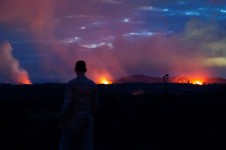 A Hawaii Air National Guard Airman observes three lava fissures at Leilani Estates and Lanipuna Gardens subdivisions in Pahoa, Hawaii, U.S., May 15, 2018. Courtesy John Linzmeier/U.S. Air National Guard/Handout via REUTERS