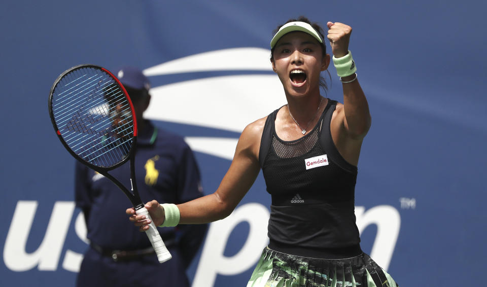 Qiang Wang, of China, reacts after defeating Ashleigh Barty, of Australia, during round four of the US Open tennis championships Sunday, Sept. 1, 2019, in New York. (AP Photo/Kevin Hagen)