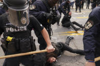 Police detain protesters, Wednesday, Sept. 23, 2020, in Louisville, Ky. A grand jury has indicted one officer on criminal charges six months after Breonna Taylor was fatally shot by police in Kentucky. The jury presented its decision against fired officer Brett Hankison Wednesday to a judge in Louisville, where the shooting took place. (AP Photo/John Minchillo)