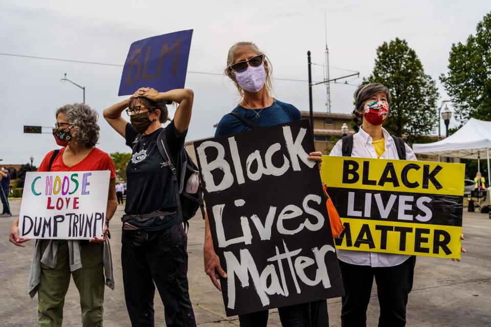 Demonstrators hold signs in front of the Kenosha Courthouse on September 01, 2020 in Kenosha, Wisconsin. (Kerem Yucel/AFP via Getty Images)