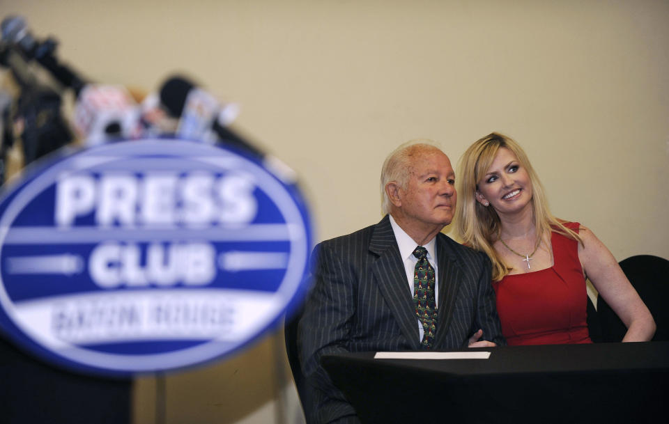 Former Louisiana Gov. Edwin Edwards, left, poses with wife Trina Scott Edwards, right, for photo, before speaking at the Baton Rouge Press Club, Monday, March 17, 2014, in Baton Rouge, La., announcing that he would join the race to represent the state’s Baton Rouge-based 6th District of the U.S. House of Representatives. Edwards served two terms as governor in the 1970s. He was re-elected in 1983 and made another comeback for a fourth term in 1991. (AP Photo/Travis Spradling)
