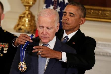 U.S. President Barack Obama presents the Presidential Medal of Freedom to Vice President Joe Biden in the State Dining Room of the White House in Washington, U.S., January 12, 2017. REUTERS/Yuri Gripas