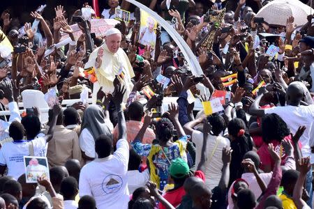 Crowds cheer as Pope Francis arrives at Kololo airstrip in Kampala, November 28, 2015. REUTERS/Giuseppe Cacace/Pool